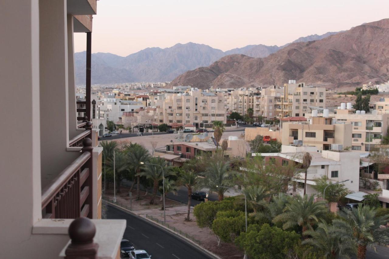 View of Aqaba's palm-lined streets and the desert mountains