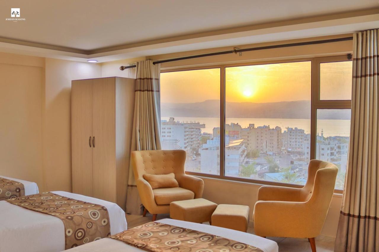 Sea view room with three single beds and armchairs, at sunset over the Gulf of Aqaba
