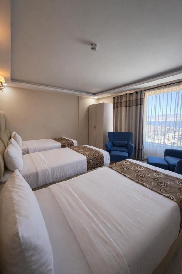 Family room with a double bed, two single beds and a sea view window
